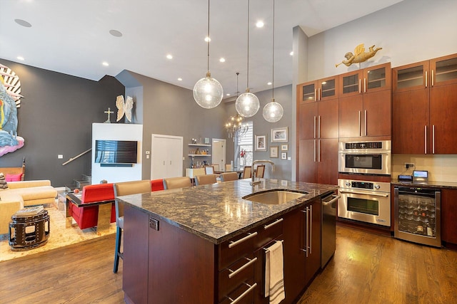 2411 W Walton St Unit 2B, Chicago, IL 60622 - kitchen with beverage cooler, dark wood-style flooring, a breakfast bar, stainless steel appliances, and open floor plan