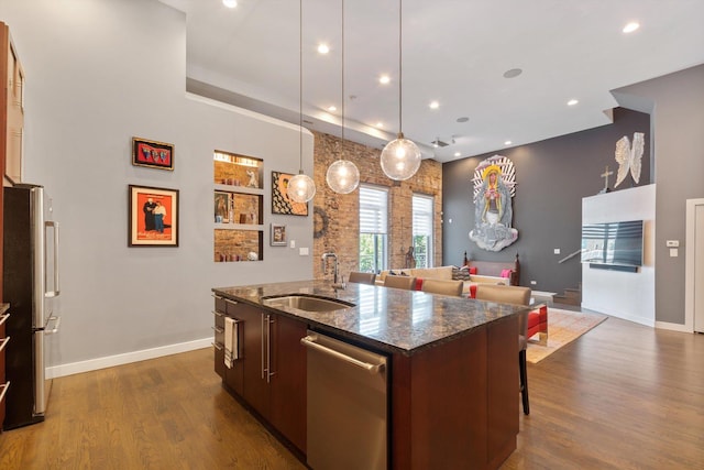 2411 W Walton St Unit 2B, Chicago, IL 60622 - kitchen featuring appliances with stainless steel finishes, a center island with sink, open floor plan, dark wood-style flooring, and recessed lighting