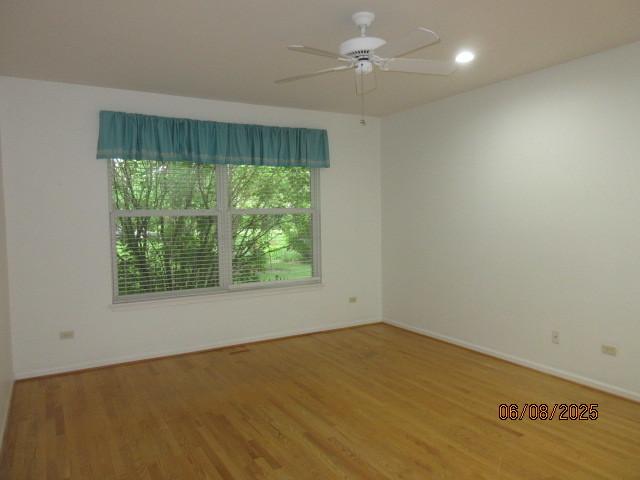 13005 Big Horn Dr, Huntley, IL 60142 - spare room featuring wood finished floors and a ceiling fan