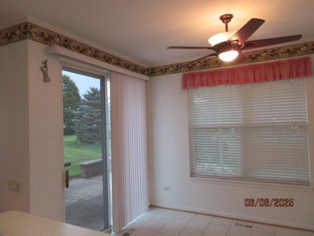13005 Big Horn Dr, Huntley, IL 60142 - unfurnished dining area with a ceiling fan and baseboards