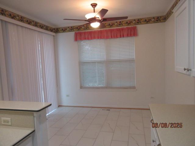 13005 Big Horn Dr, Huntley, IL 60142 - unfurnished dining area with ceiling fan and light marble finish floors
