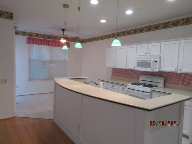 13005 Big Horn Dr, Huntley, IL 60142 - kitchen featuring white appliances, a ceiling fan, backsplash, white cabinets, and recessed lighting