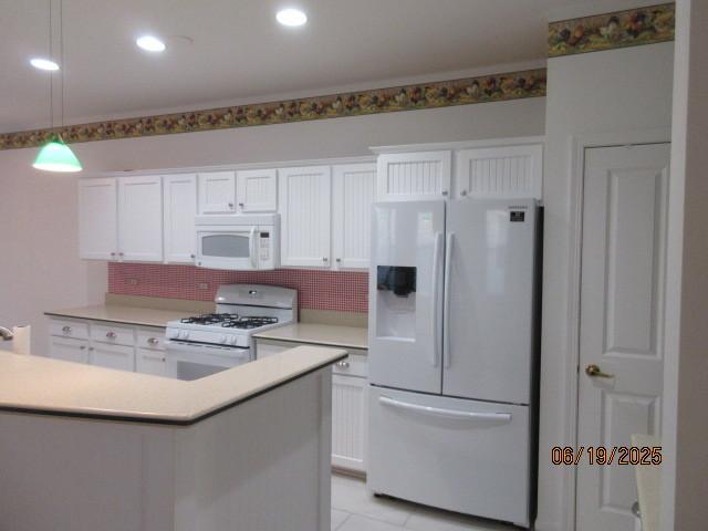 13005 Big Horn Dr, Huntley, IL 60142 - kitchen with white appliances, white cabinetry, decorative backsplash, and light countertops