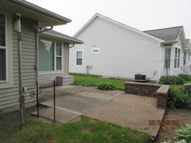 13005 Big Horn Dr, Huntley, IL 60142 - view of side of property featuring a patio and roof with shingles