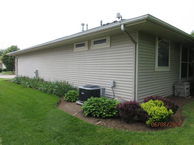 13005 Big Horn Dr, Huntley, IL 60142 - view of side of home featuring a cooling unit and a yard