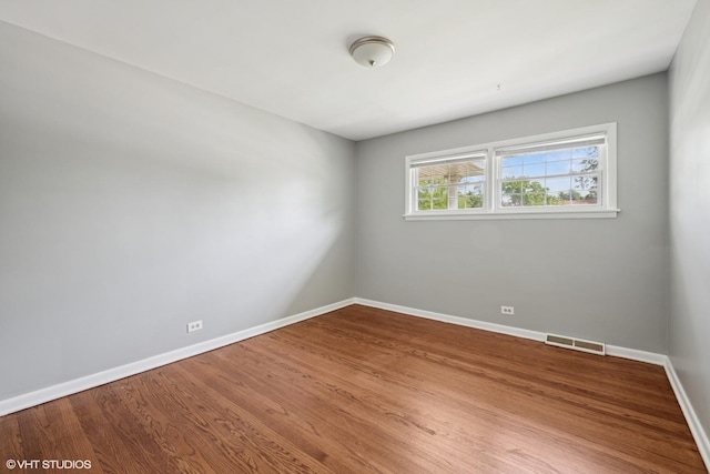 1419 W Miner St, Arlington Heights, IL 60005 - spare room featuring baseboards and wood finished floors