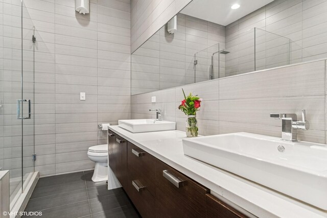 1718 W Le Moyne St Unit 1, Chicago, IL 60622 - bathroom featuring tile walls, double vanity, tile patterned flooring, and a stall shower