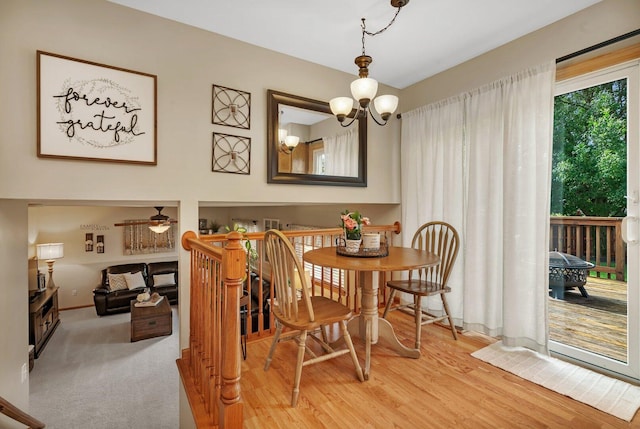 512 Creekside Cir, Minooka, IL 60447 - dining area featuring a chandelier, ceiling fan, and light wood-style floors