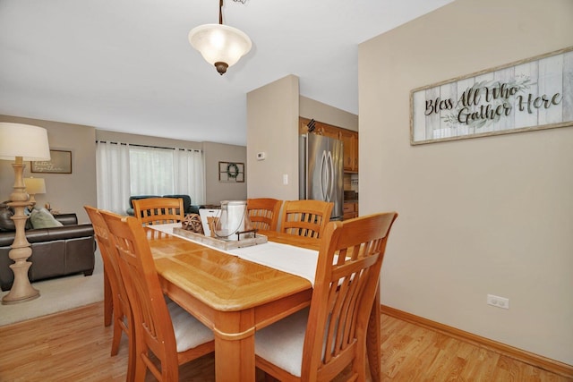 512 Creekside Cir, Minooka, IL 60447 - dining area with light wood-style flooring and baseboards
