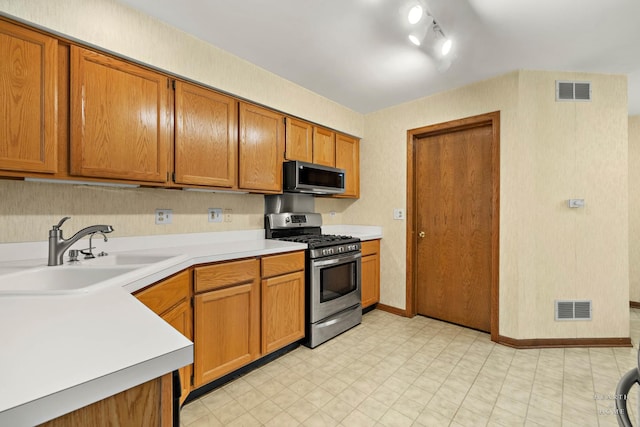 314 Spring Creek Cir, Schaumburg, IL 60173 - kitchen featuring stainless steel appliances, light flooring, light countertops, and brown cabinetry