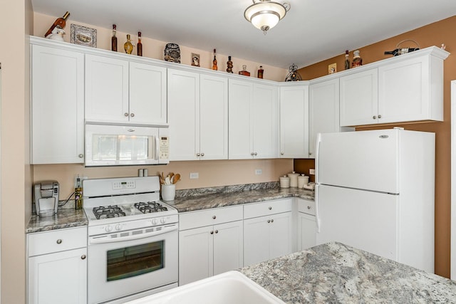 4115 Dalewood Dr, Plainfield, IL 60586 - kitchen with white appliances, white cabinets, and light stone counters