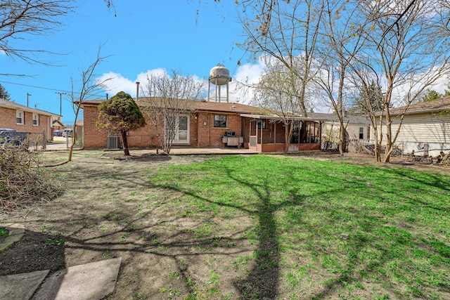 12801 W Playfield Dr, Crestwood, IL 60418 - rear view of house featuring a sunroom, a yard, a patio area, and brick siding