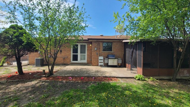 12801 W Playfield Dr, Crestwood, IL 60418 - back of property with brick siding, a sunroom, and a patio