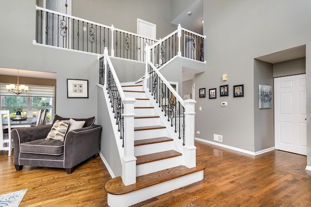 923 Christa Ct, Elk Grove Village, IL 60007 - stairway with a towering ceiling, a chandelier, and wood finished floors