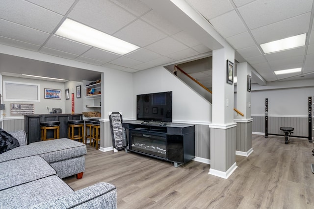 923 Christa Ct, Elk Grove Village, IL 60007 - living area with bar area, light wood finished floors, a drop ceiling, stairs, and a wainscoted wall