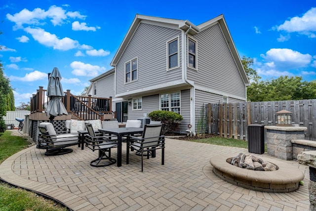 923 Christa Ct, Elk Grove Village, IL 60007 - fenced backyard with a patio area, outdoor dining area, and a fire pit