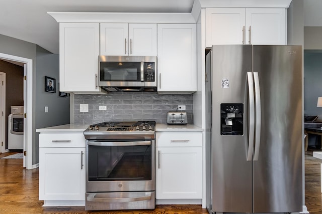 923 Christa Ct, Elk Grove Village, IL 60007 - kitchen featuring appliances with stainless steel finishes, washer / dryer, light countertops, and backsplash