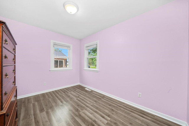 9111 Memory Trl, Wonder Lake, IL 60097 - unfurnished bedroom featuring dark wood-style flooring and baseboards