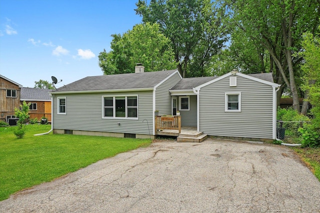 9111 Memory Trl, Wonder Lake, IL 60097 - view of front of property featuring a wooden deck, a shingled roof, and a chimney