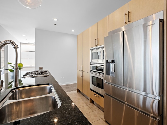 653 N Kingsbury St Unit 1707, Chicago, IL 60654 - kitchen featuring appliances with stainless steel finishes, dark stone countertops, light brown cabinetry, light tile patterned flooring, and recessed lighting