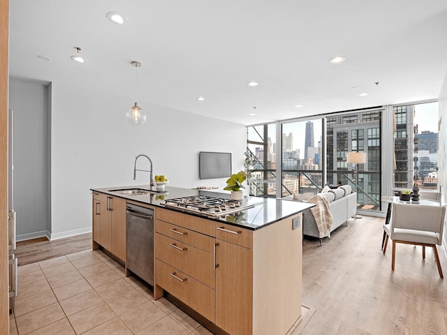 653 N Kingsbury St Unit 1707, Chicago, IL 60654 - kitchen featuring appliances with stainless steel finishes, a center island with sink, open floor plan, hanging light fixtures, and recessed lighting