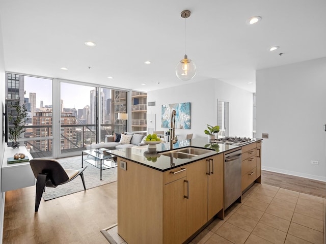 653 N Kingsbury St Unit 1707, Chicago, IL 60654 - kitchen featuring stainless steel appliances, dark countertops, a center island with sink, recessed lighting, and hanging light fixtures