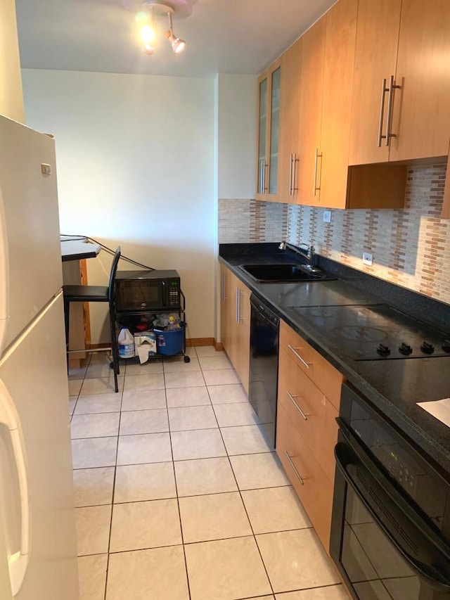 4250 N Marine Dr Unit 1404, Chicago, IL 60613 - kitchen featuring black appliances, light tile patterned floors, dark countertops, and decorative backsplash