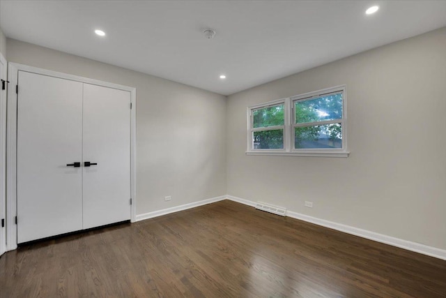 3935 W Jarvis Ave, Lincolnwood, IL 60712 - unfurnished bedroom featuring dark wood-style floors, recessed lighting, and a closet