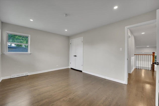 3935 W Jarvis Ave, Lincolnwood, IL 60712 - empty room with dark wood-style flooring, a smoke detector, and recessed lighting