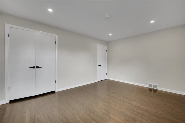 3935 W Jarvis Ave, Lincolnwood, IL 60712 - unfurnished bedroom with dark wood-style flooring and recessed lighting