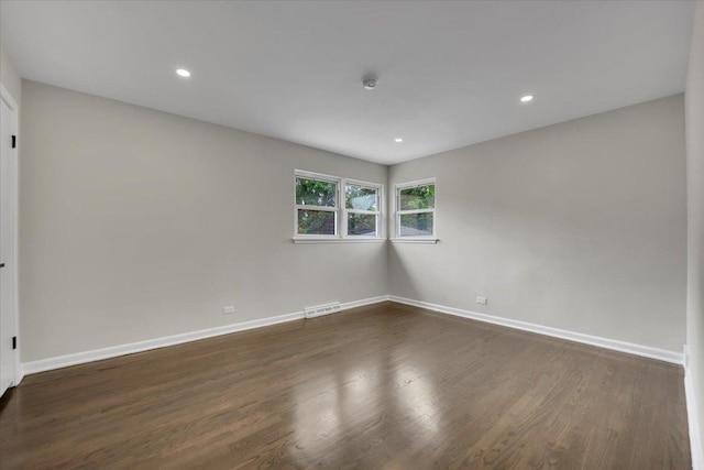 3935 W Jarvis Ave, Lincolnwood, IL 60712 - spare room featuring dark wood-style flooring and recessed lighting