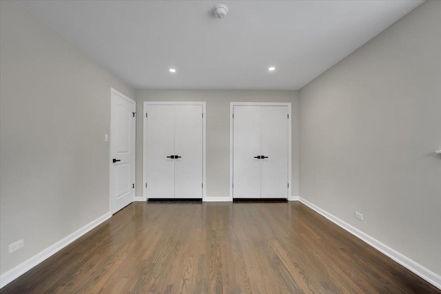 3935 W Jarvis Ave, Lincolnwood, IL 60712 - unfurnished bedroom with dark wood-style floors and recessed lighting