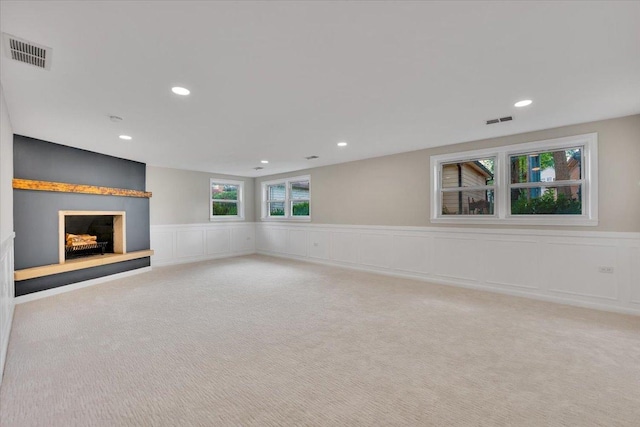 3935 W Jarvis Ave, Lincolnwood, IL 60712 - unfurnished living room with carpet floors, wainscoting, a fireplace with raised hearth, recessed lighting, and a decorative wall