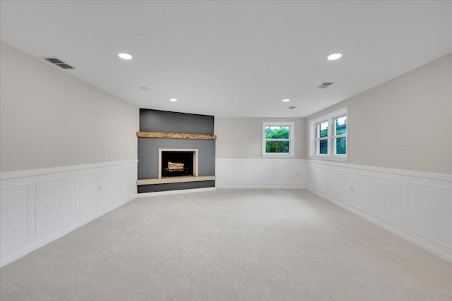 3935 W Jarvis Ave, Lincolnwood, IL 60712 - unfurnished living room featuring a decorative wall, carpet, a wainscoted wall, a fireplace with raised hearth, and recessed lighting