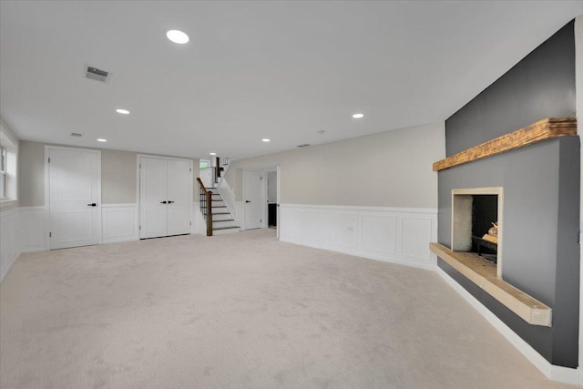 3935 W Jarvis Ave, Lincolnwood, IL 60712 - basement with stairs, light carpet, a wainscoted wall, recessed lighting, and a decorative wall