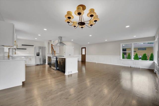 3935 W Jarvis Ave, Lincolnwood, IL 60712 - unfurnished living room featuring a chandelier, dark wood-type flooring, wainscoting, recessed lighting, and a decorative wall