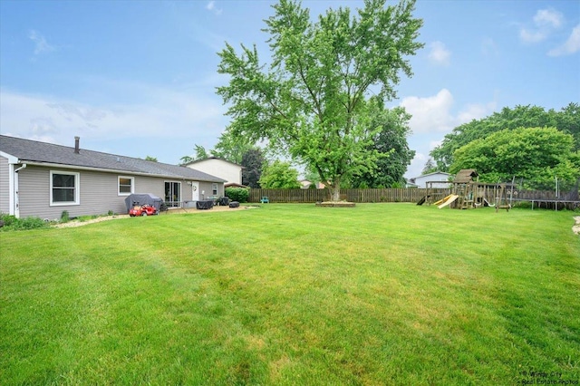 8246 N Applewood Ct, Hanover Park, IL 60133 - fenced backyard featuring a playground