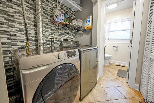 8246 N Applewood Ct, Hanover Park, IL 60133 - laundry area with separate washer and dryer and light tile patterned floors