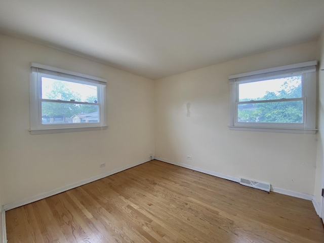 234 Tahoe Dr, Chicago Heights, IL 60411 - empty room with plenty of natural light and light wood-style floors