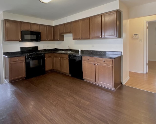234 Tahoe Dr, Chicago Heights, IL 60411 - kitchen with black appliances, dark wood-style flooring, and dark stone countertops