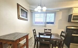 1915 Whitechapel Dr Unit 1A, Mount Prospect, IL 60056 - dining area featuring a chandelier and tile patterned flooring