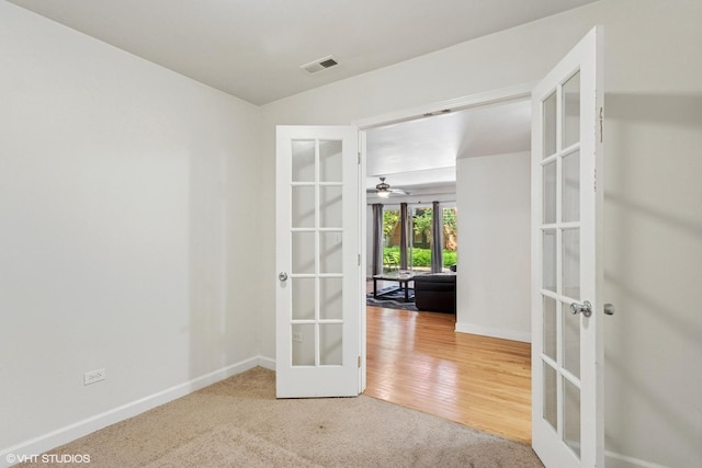 6427 N Damen Ave Unit 1E, Chicago, IL 60645 - carpeted empty room with french doors and a ceiling fan