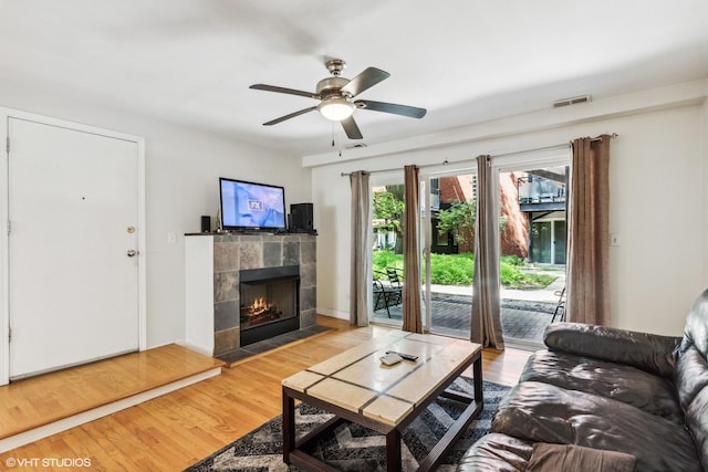 6427 N Damen Ave Unit 1E, Chicago, IL 60645 - living room featuring light wood-style flooring, a fireplace, and ceiling fan