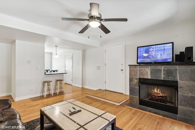6427 N Damen Ave Unit 1E, Chicago, IL 60645 - living room featuring wood finished floors, ceiling fan, and a fireplace