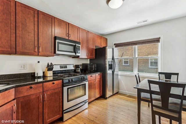 6427 N Damen Ave Unit 1E, Chicago, IL 60645 - kitchen with appliances with stainless steel finishes and light wood-style floors