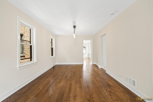 8207 S Laflin St, Chicago, IL 60620 - empty room with plenty of natural light and dark wood-type flooring