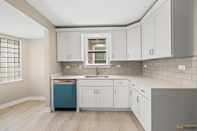 8207 S Laflin St, Chicago, IL 60620 - kitchen with dishwasher, light wood-type flooring, light countertops, decorative backsplash, and white cabinetry