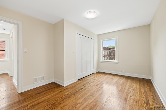 8207 S Laflin St, Chicago, IL 60620 - unfurnished bedroom featuring light wood-style flooring and a closet