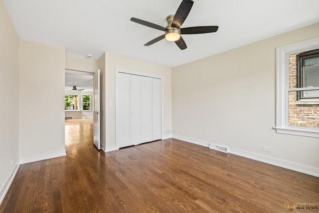 8207 S Laflin St, Chicago, IL 60620 - unfurnished bedroom with dark wood-style flooring, a closet, and a ceiling fan