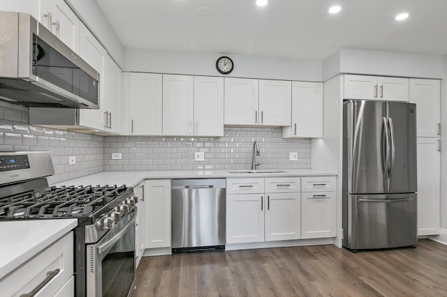 4210 N Natchez Ave Unit 208, Chicago, IL 60634 - kitchen with stainless steel appliances, light countertops, dark wood finished floors, and recessed lighting